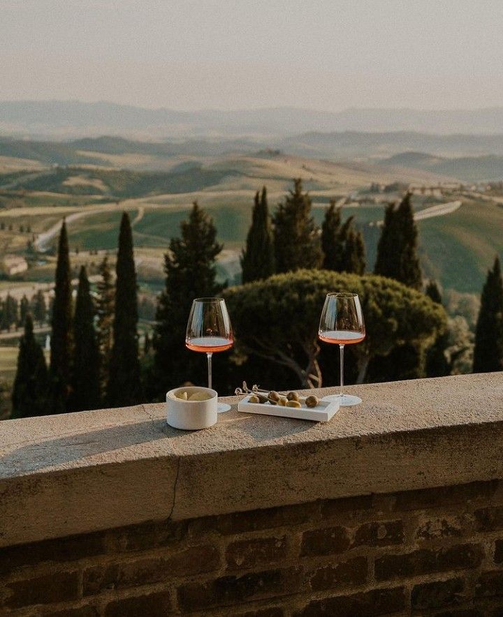 Two glasses of wine with a panoramic landscape