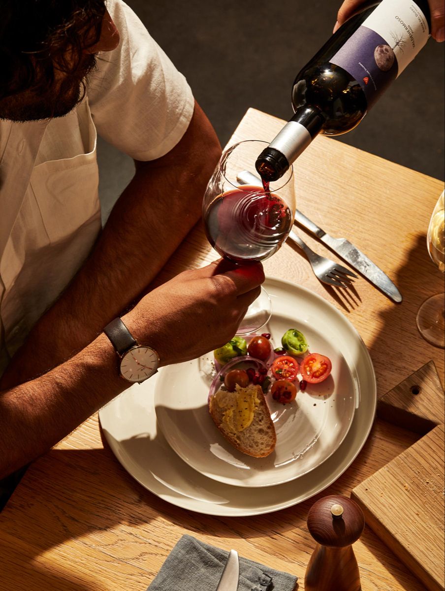 Pouring red wine at a restaurant table